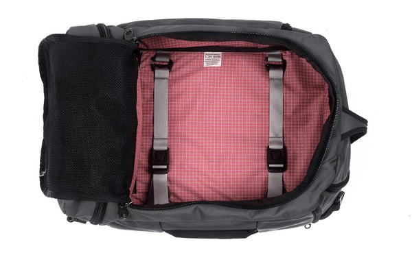 An open Techonaut 30 with a Nebulous Grey (dark grey) exterior and an Sakura (pale pink) interior.